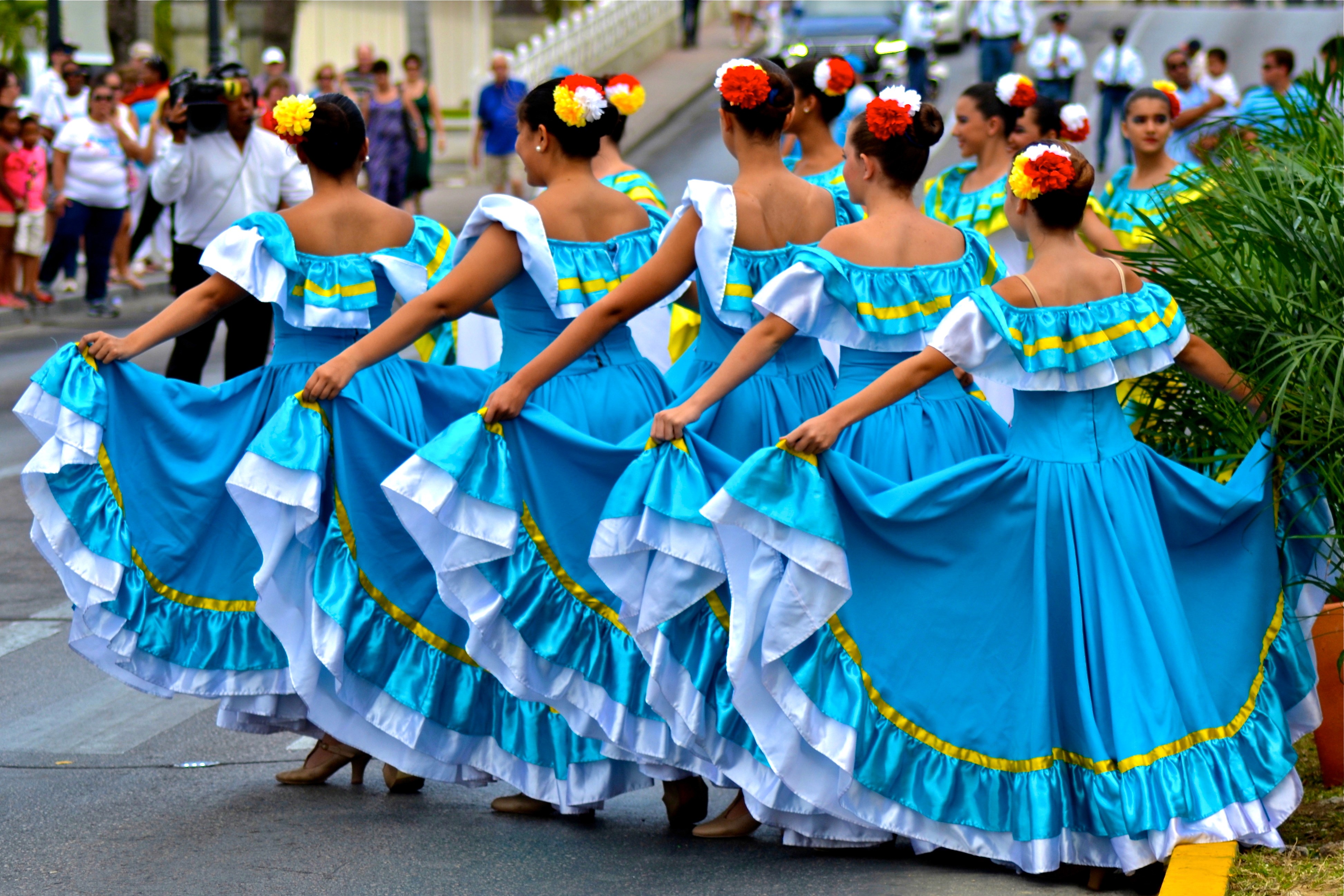 Dancers in blue dresses at an Aruba celebration.